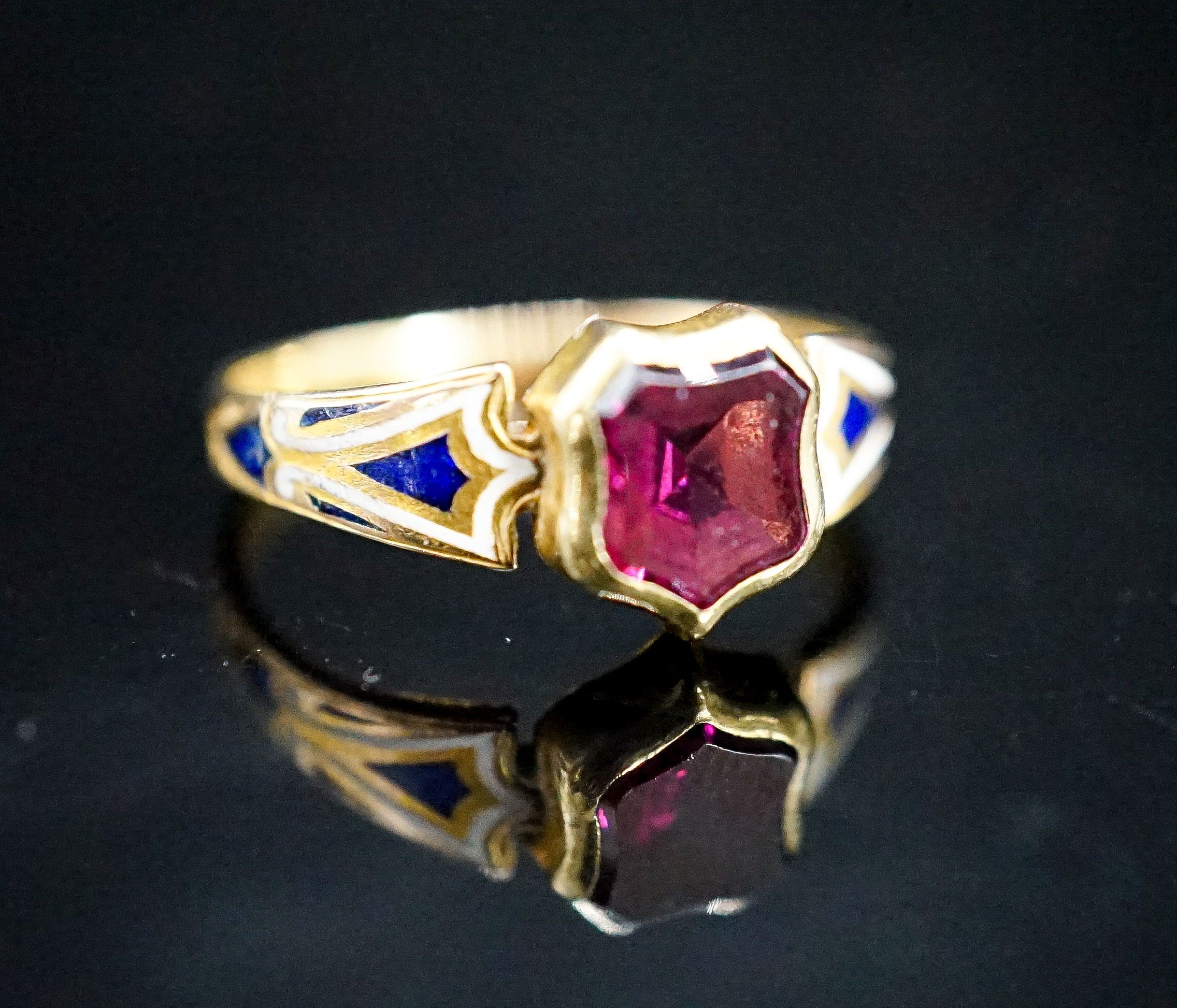 A Victorian two coloured enamel, yellow metal and foiled garnet signet ring, size M